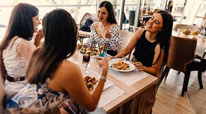 A group of women eating at a restaurant together