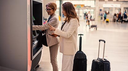 Image of two women using an ATM