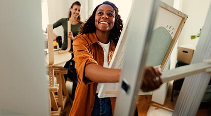Image of a woman smiling while getting ready to move in to a new home