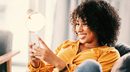 A woman texting on her phone and smiling