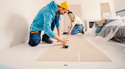 Image of two people building a construction project together