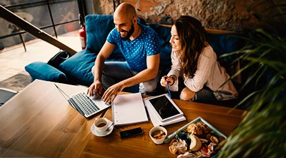two people working on a laptop