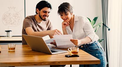 Two people sitting at a table looking at paperwork