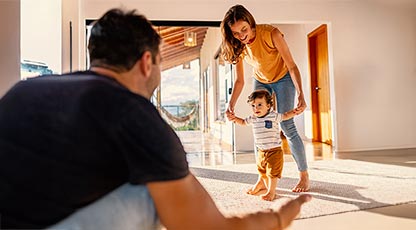 Image of a young kid learning to walk