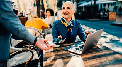 A woman sitting at a table with her laptop