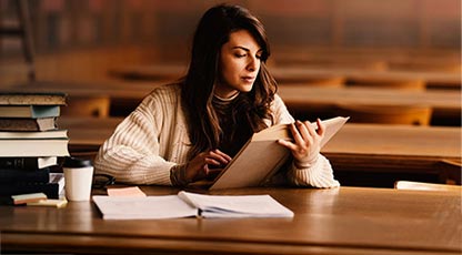 person reading a book in a library
