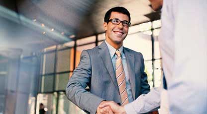 Two men in suits shaking hands