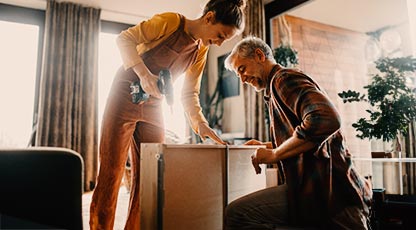Two people building a table