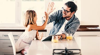 A parent and child high five each other