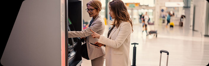 Image of two women using an ATM