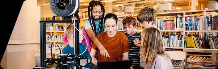 Image of a woman and group of children in a library