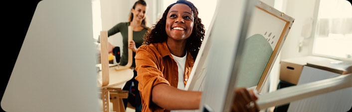 Image of a woman smiling while getting ready to move in to a new home